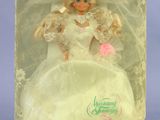 barbie doll in a box with a white dress and pink shoes