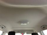 someone is sitting in the back seat of a car with a cell phone in their hand