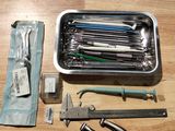 a box of tools sitting on a table next to a pair of scissors