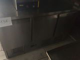 a stainless steel refrigerator with a sign on the door