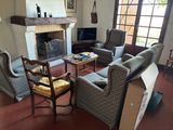 an image of a living room with couches, chairs and a fire place