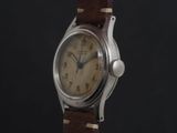 a close up of a wrist watch with a brown leather strap