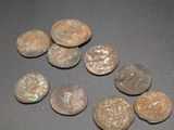 some old coins sitting on top of a table next to each other