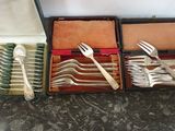 a lot of forks and spoons in a case