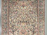 an antique persian rug with birds and trees on it
