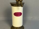an old fashioned coffee grinder is sitting on a table