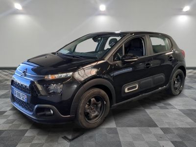 the small black car is parked in a room with a checkered floor