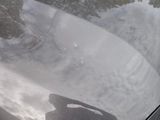 a reflection of a person on the hood of a car