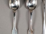 three spoons and two spoon spoons on a table