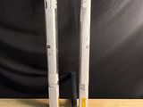 two baseball bats sitting on a table next to each other