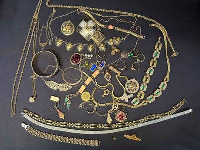 a lot of gold jewelry on a black table