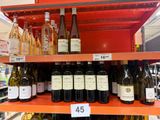 many bottles of wine on the shelves in the store
