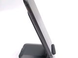 a cell phone on a stand on a white surface