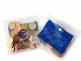 two bags of coins sitting next to each other on a table