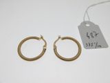 a pair of gold hoop earrings
