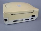 a yellow nintendo game console sitting on a gray surface