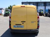 a yellow van that is parked in a parking lot