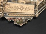 a mirror with a floral design on it on a black surface