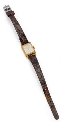 a close up of a watch on a white surface with a white background