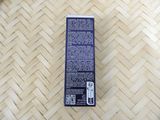 a box of toothpaste sitting on a wooden floor