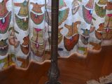 a lamp that is on a stand in front of a curtain