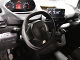 a dashboard of a car with a steering wheel and a dash light