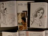 sketches of a woman sitting in a chair in front of a bunch of books