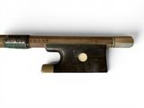 a close up of a violin bow on a white surface
