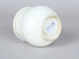 an image of a white vase with a label on it