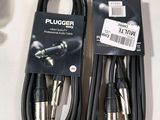 two black and silver plugger cables sitting on top of a white table