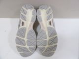 pair of gray and white running shoes on a white surface