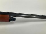 a close up of a rifle on a white surface