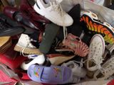 many pairs of shoes in a bag on the floor