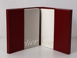 a close up of a book with a red cover and white pages