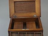 a small wooden box with compartments inside of it