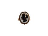 a close up of a ring with a woman ' s face on it