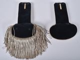 two pairs of black and white earrings with fringes hanging from them