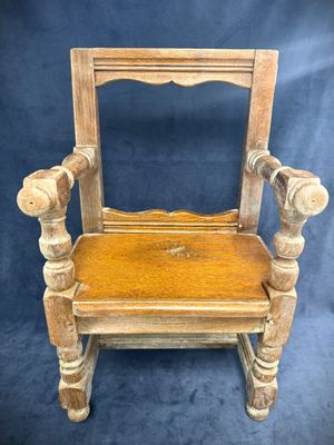 an old wooden chair with a mirror on the back of it