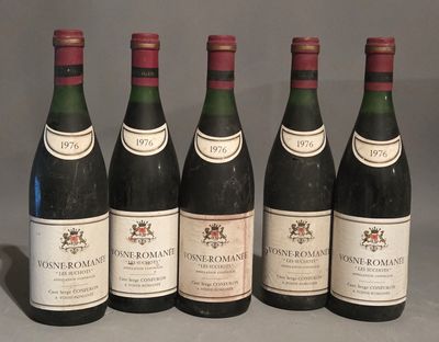 six bottles of wine are lined up in a row on a table