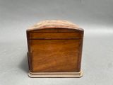 an old wooden box sitting on top of a gray surface