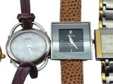 three different watches and a gold watch on a white background