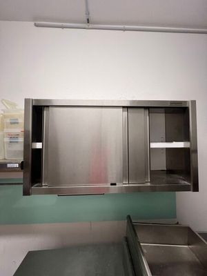 a stainless steel sink in the middle of a kitchen
