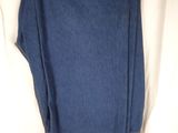 blue jeans hanging on a clothes rack on a white sheet