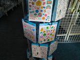 a stack of boxes with stickers on them in a store