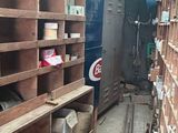 a room filled with lots of wooden shelves and boxes