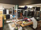 a room with a lot of clutter on the shelves