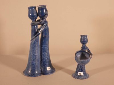 two blue vases sitting next to each other on a table