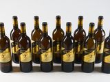 six bottles of wine are lined up in a row on a white surface