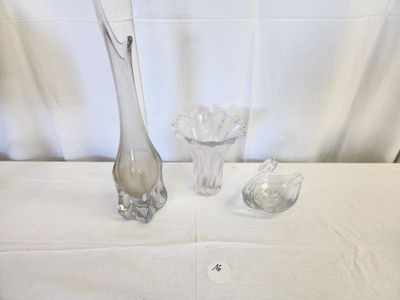 three glass vases and a spoon on a table