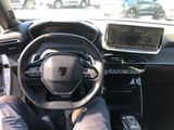 a man sitting in the driver ' s seat of a car